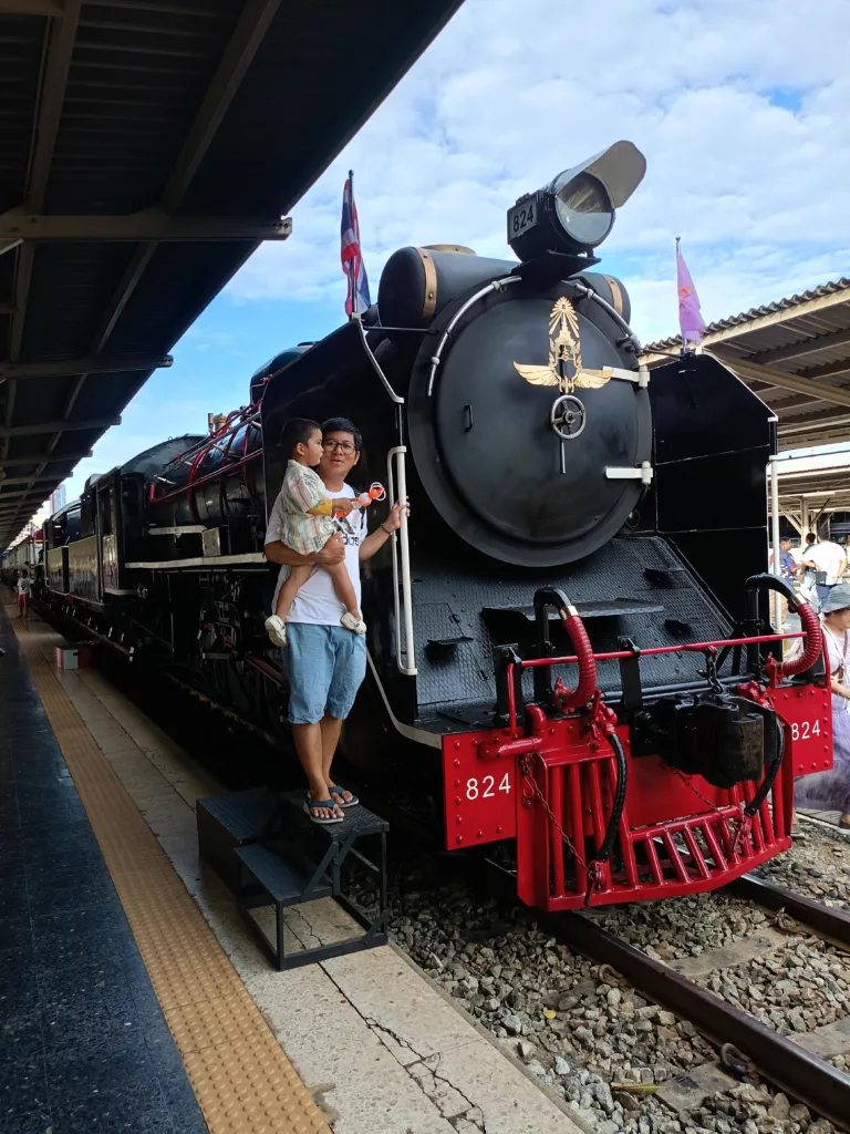 My son and I with a vintage Steam Locomotive Number 824 of State Railway of Thailand in 2024 at Hua Lamphong Train Station (former Bangkok Central Train Station)