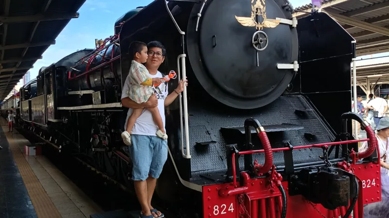 My son and I with a vintage Steam Locomotive Number 824 of State Railway of Thailand in 2024 at Hua Lamphong Train Station (former Bangkok Central Train Station)